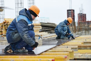 construction worker at construction site assembling falsework for concrete pouring